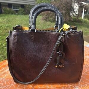 Coach Rogue 1941 bag in oxblood pebbled leather with whipstitch handles.